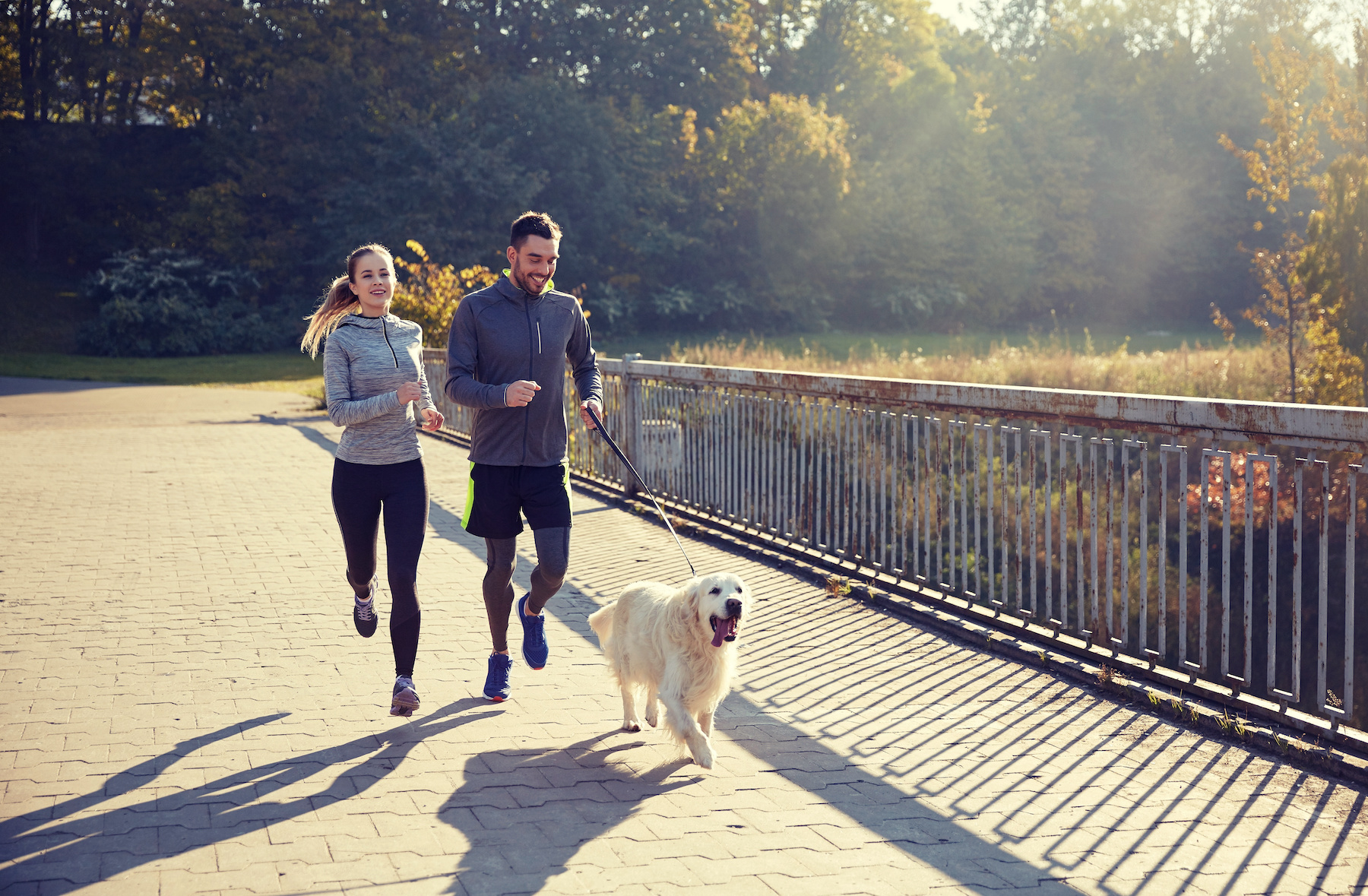couple jogging with dog